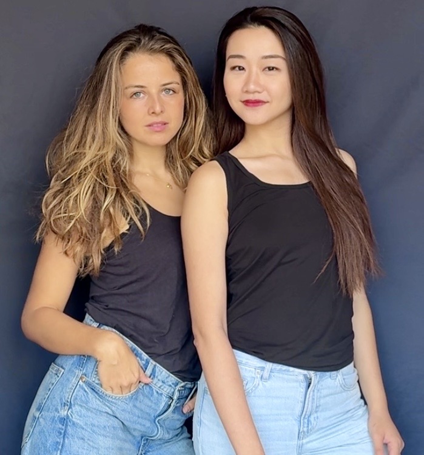 Selina and Lalia, the founders of Pebble Theatre, against a deep blue backdrop.